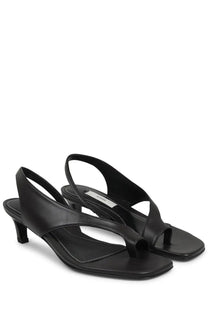 Toteme women’s black leather heeled sandal with minimalist design and low heel shown from the back side