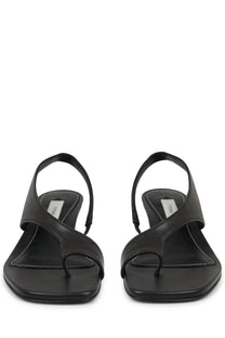 Toteme women’s black leather thong sandals with minimalist design and subtle white stitching along the edges