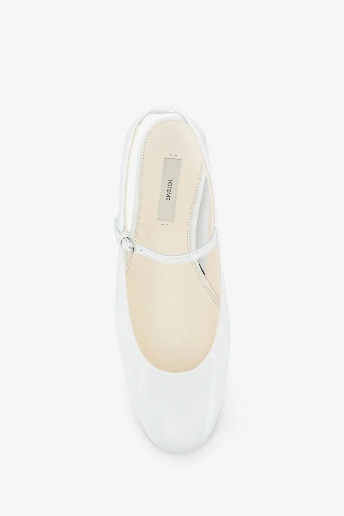 Toteme women’s white patent leather mary jane flat shoe with sleek minimalist design and small silver buckle