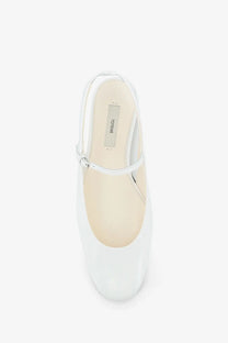 Toteme women’s white patent leather mary jane flat shoe with sleek minimalist design and small silver buckle