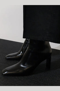 Toteme women’s black leather ankle boots with sleek square-toe design and modest block heel