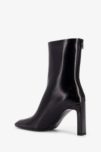 Toteme women’s black leather ankle boot with square toe and block heel in patent leather finish