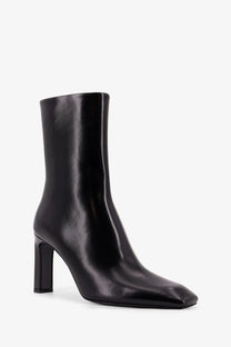 Toteme women’s black leather ankle boot with patent leather, square toe, and block heel visible from the back side