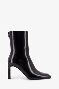 Toteme women’s black leather ankle boot with sleek square toe and block heel in patent leather finish