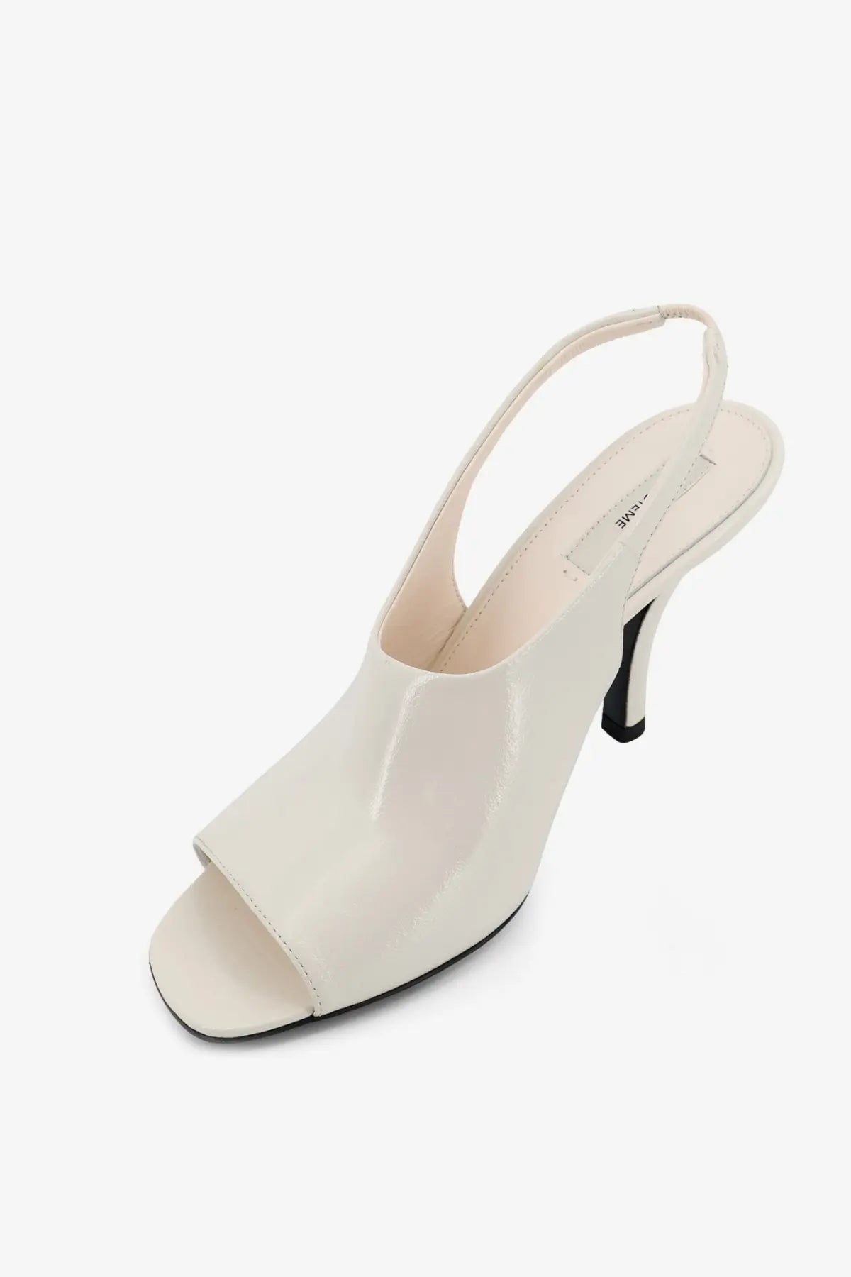 Toteme women’s white leather contour slingback heel with cream-colored patent leather and black sole minimalist design