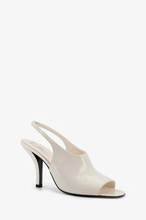 Toteme women’s white cream-colored patent leather slingback heel sandal with sleek minimalist design and black sole