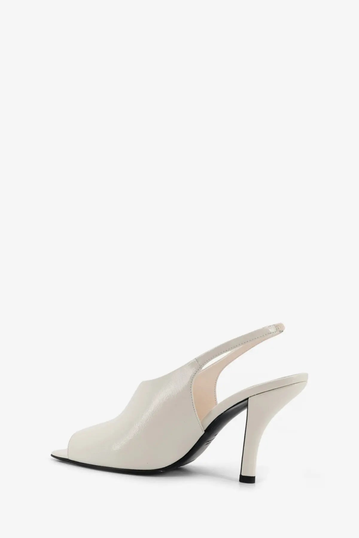 Toteme women’s leather contour sandals in cream patent leather with sleek minimalist design and black slingback heel