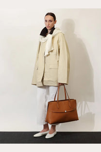 Tan leather tote bag with top handle and front flap closure by toteme in beige for women