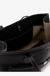 Toteme women’s black leather tote bag with textured leather, white stitching, and beige interior lining