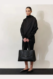 Black leather tote bag with structured design and top handles from Toteme womens shoulder bags collection