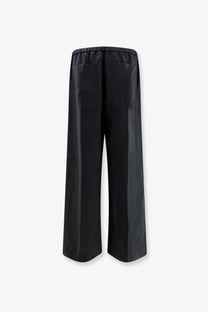 Back view of toteme womens black linen and lyocell blend wide-leg trousers with elastic waistband and two rear pockets
