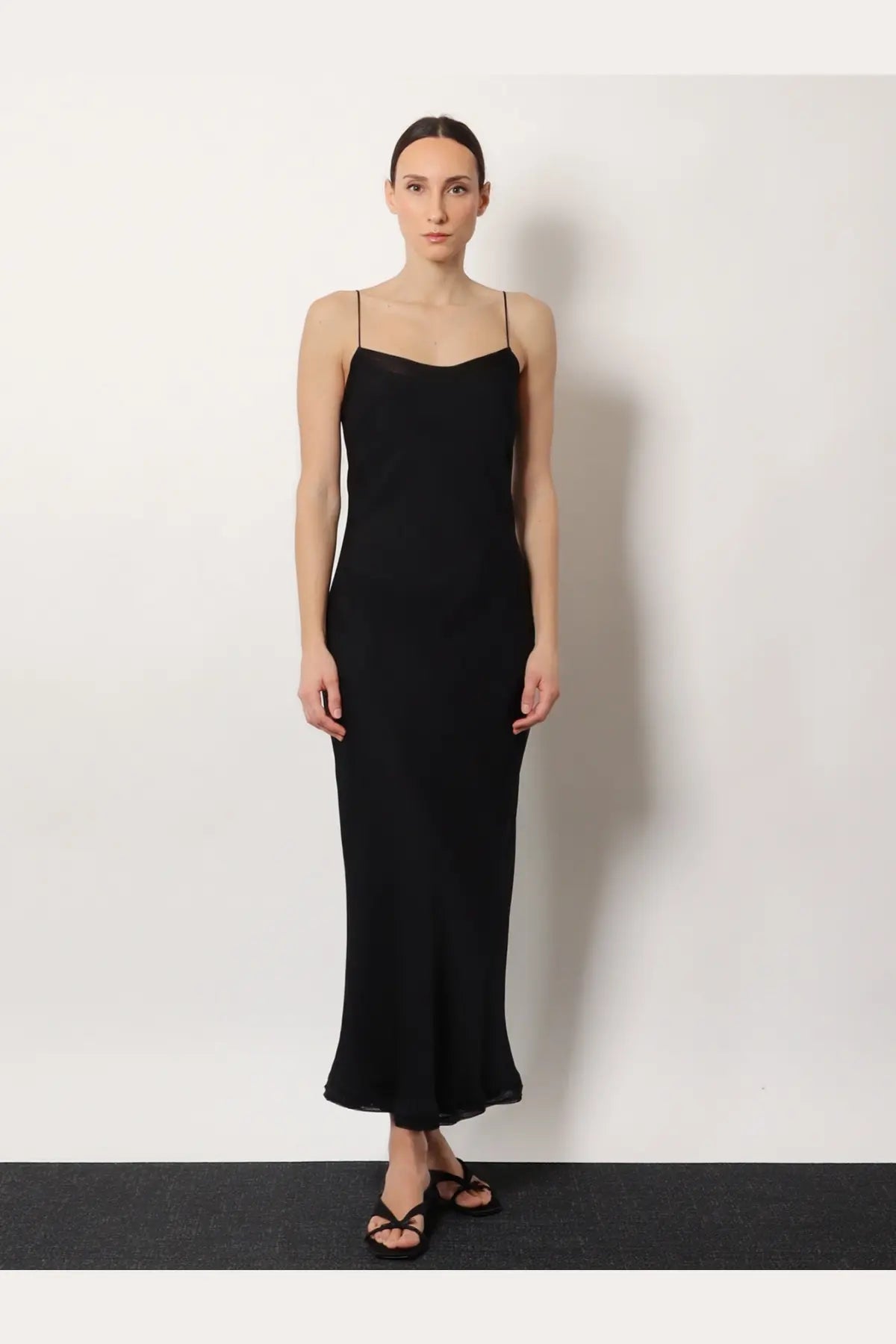 Toteme women’s long black silk dress with spaghetti straps and sleek flowing silhouette