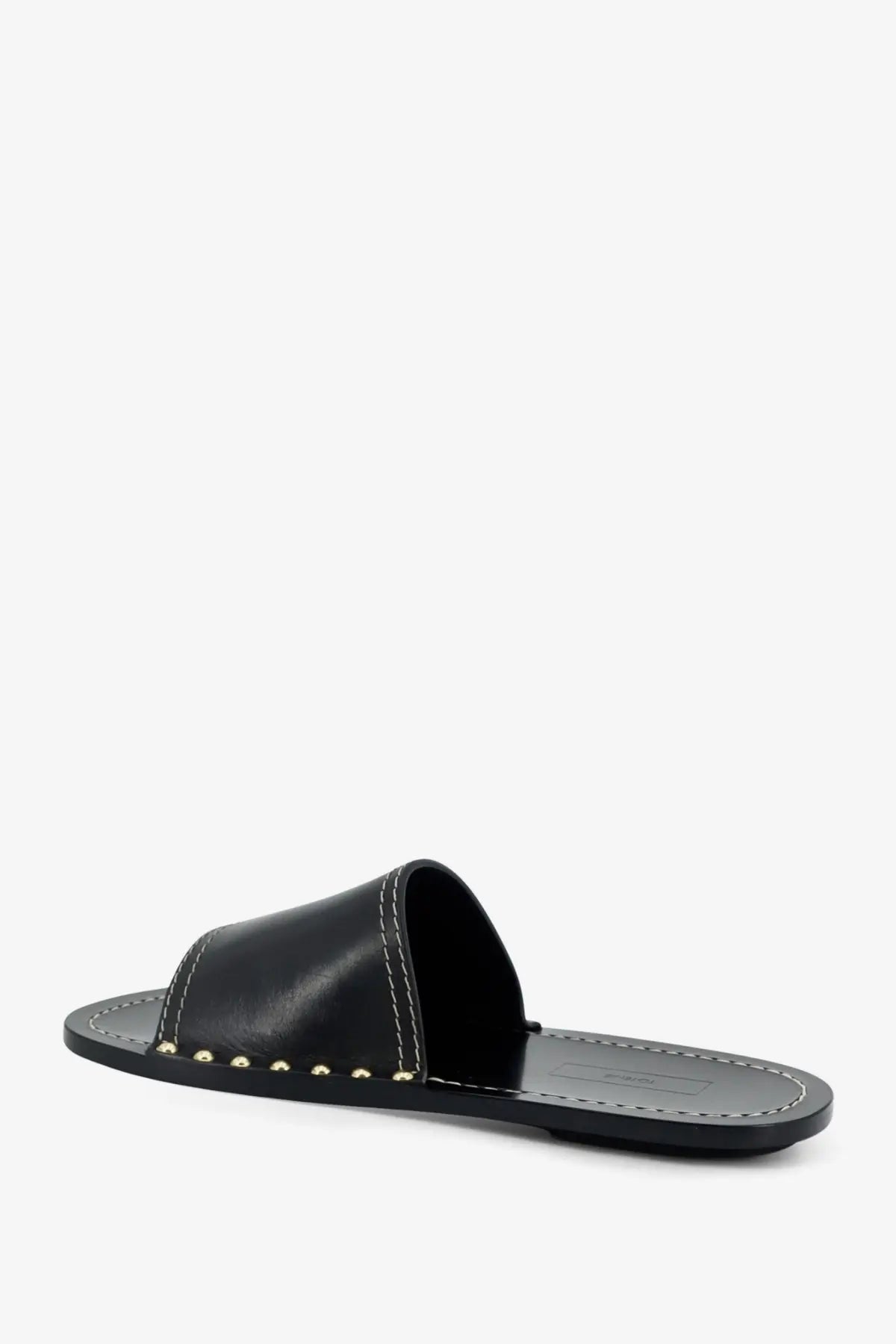 Toteme women’s low black leather slide sandal with gold-tone studs and white contrast stitching along the edge