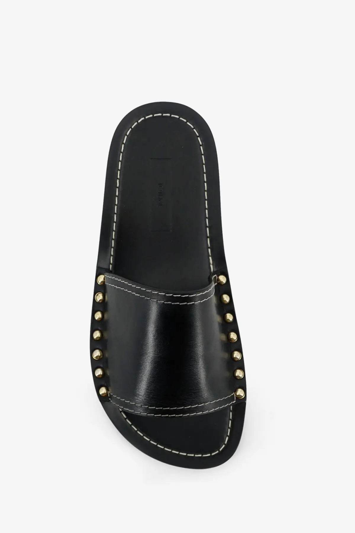 Toteme women’s low black leather slide sandal with gold-tone studs and white stitching on the strap