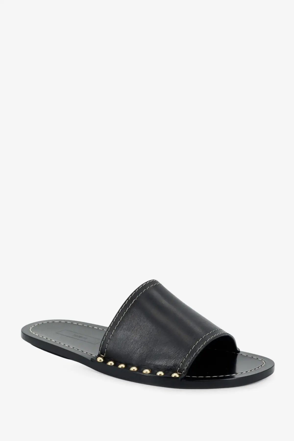 Black leather slide sandal by Toteme with gold-tone studs along the edge in a low heel design