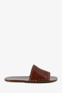 Toteme women’s brown leather slide sandal with contrasting white stitching and minimalist design