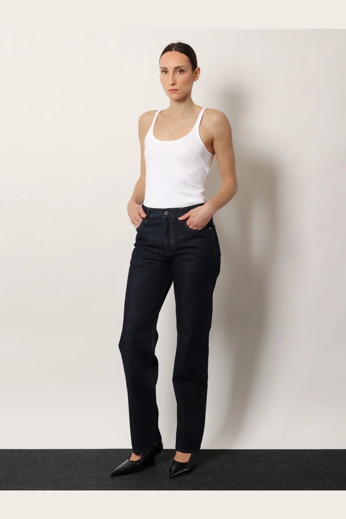 Black high-waisted straight-leg denim jeans by Toteme made from durable denim fabric in a classic style