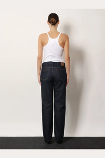 Toteme women’s low straight denim jeans in dark indigo with a brown leather patch on the back waistband