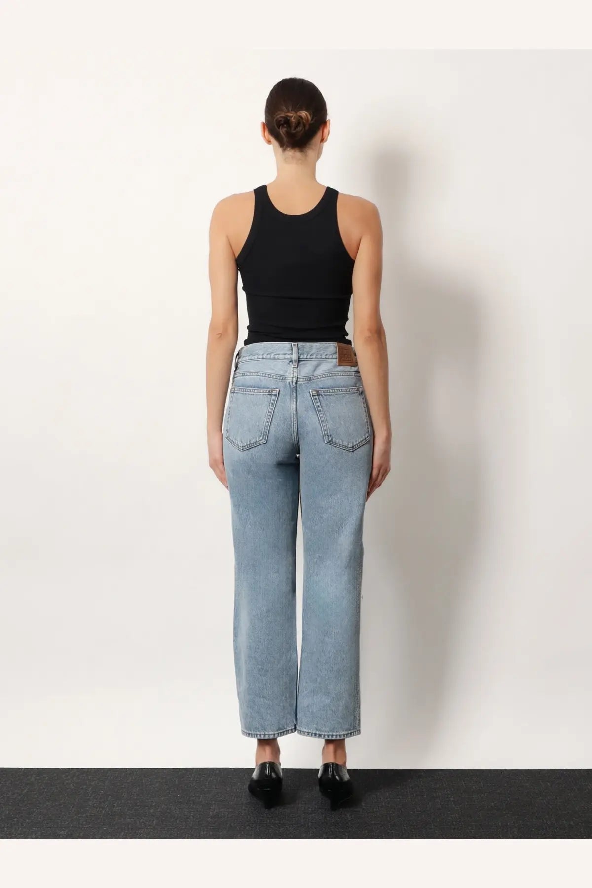 Toteme women’s low straight grey organic cotton jeans shown from the back with classic back pockets