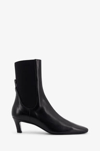 Toteme women’s the mid heel boot black leather ankle boot with sleek pointed toe and low heel in front view