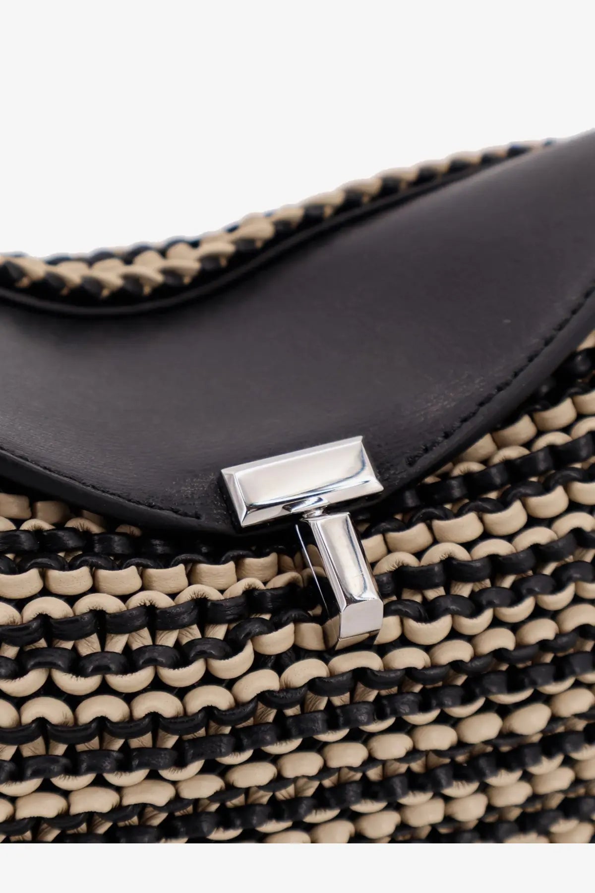 Toteme women’s mini lock clutch in black leather with black and beige woven strap and silver-tone t logo clasp