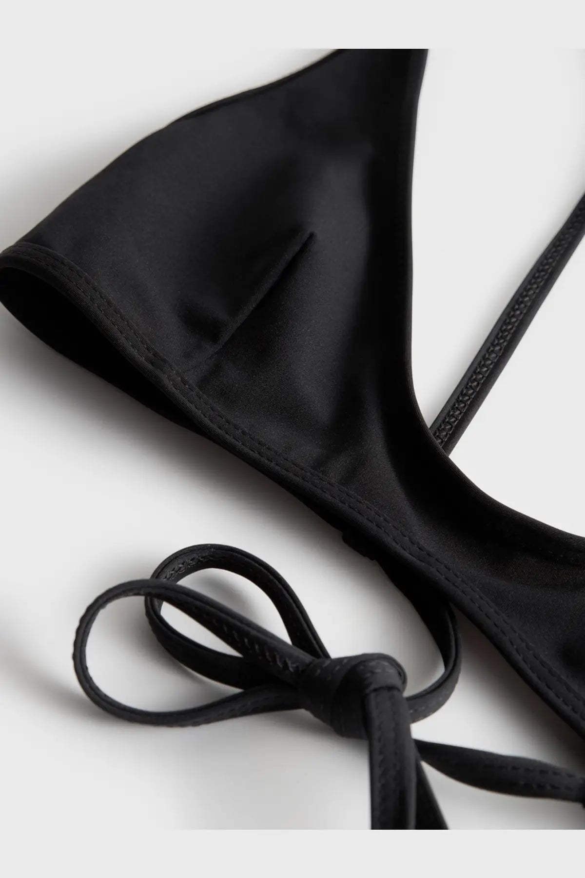 Toteme women’s black nylon satin triangle bikini top with adjustable tie straps for a customizable fit