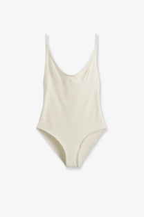 Toteme women’s cream nylon one-piece swimsuit with thin spaghetti straps and sleek minimalist design front view