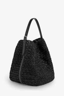 Toteme women’s raffia shoulder bag in black woven straw with leather handles and a silver-toned buckle