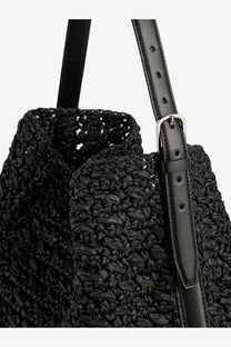 Toteme women’s black woven straw tote bag with leather straps and silver-toned buckle for shoulder carry