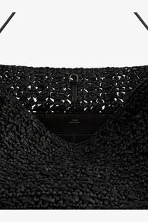 Toteme women’s raffia shoulder bag in black woven straw with sleek metal clasp and leather interior label