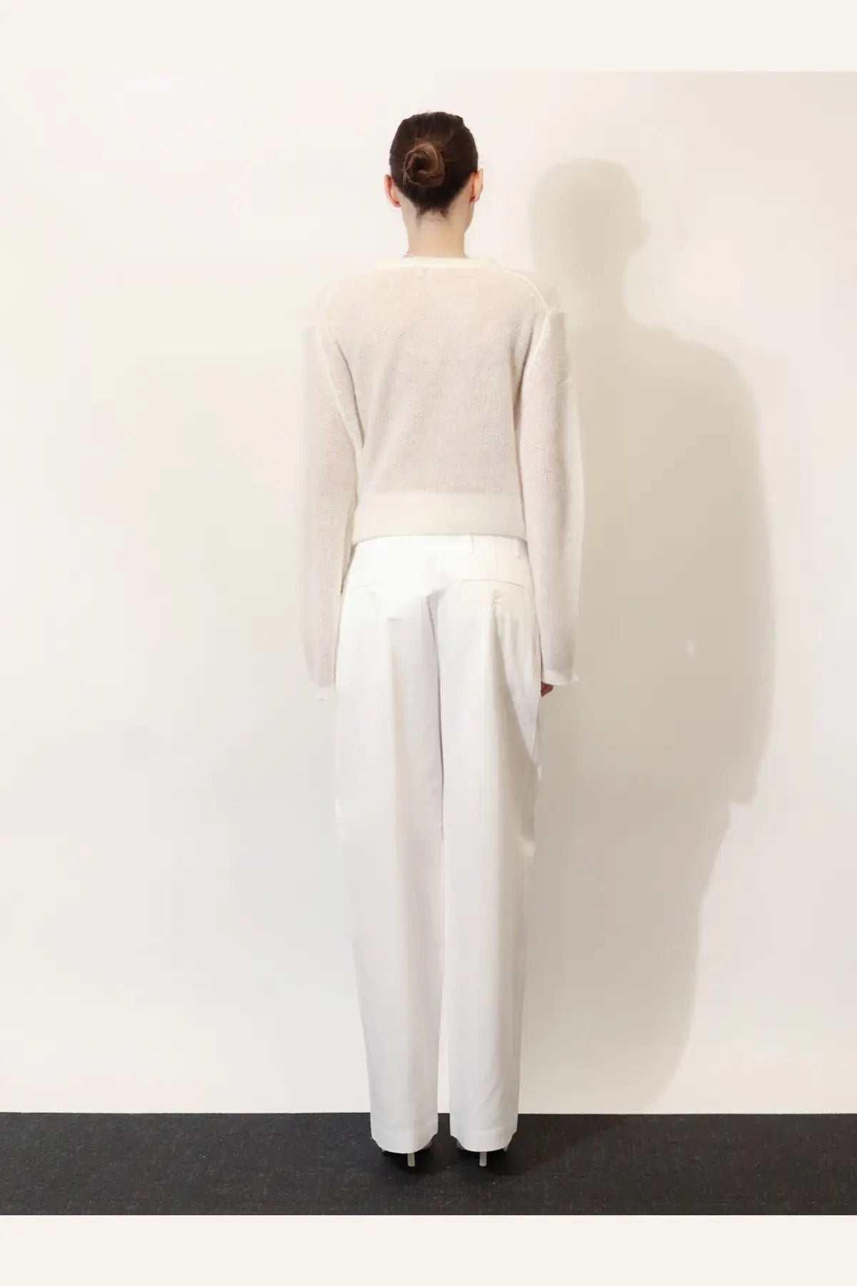 Toteme white minimalist knit sweater with long sleeves and relaxed fit made from soft cotton blend