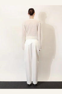 Toteme white minimalist knit sweater with long sleeves and relaxed fit made from soft cotton blend