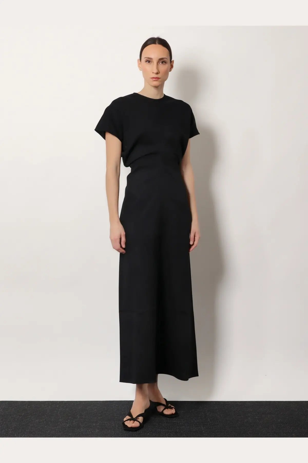 Toteme women’s black wool dress with short sleeves and slouch waistline in a minimalist design