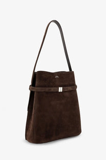 Toteme women’s brown suede shoulder bag with sleek black strap and silver toned buckle accent