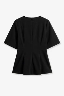 Back view of toteme women’s tailored black cotton peplum top with short sleeves and central zipper closure