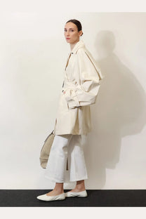 Toteme women’s trench coat in cream beige washed cotton with oversized fit belted waist and wide sleeves
