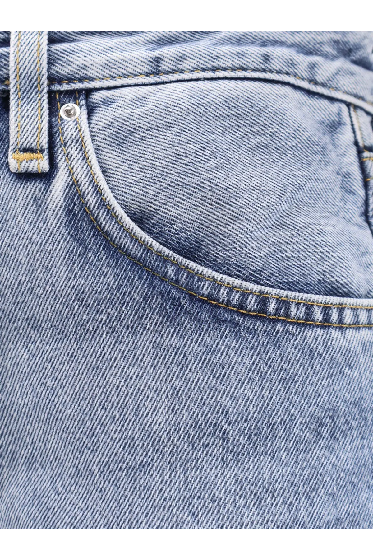 Toteme women’s twisted seam organic cotton jeans in light-wash blue with yellow stitching and a classic faded look