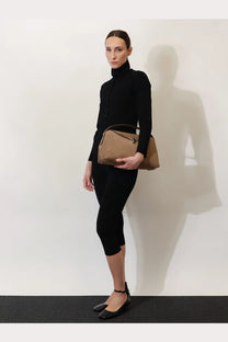 Toteme women’s black viscose blend cardigan paired with a tan leather crossbody bag with minimalist design and gold hardware