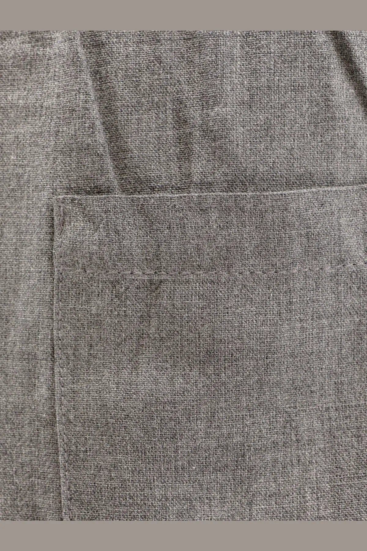 Gray heathered viscose fabric pocket with subtle woven texture on Toteme women’s trousers back side