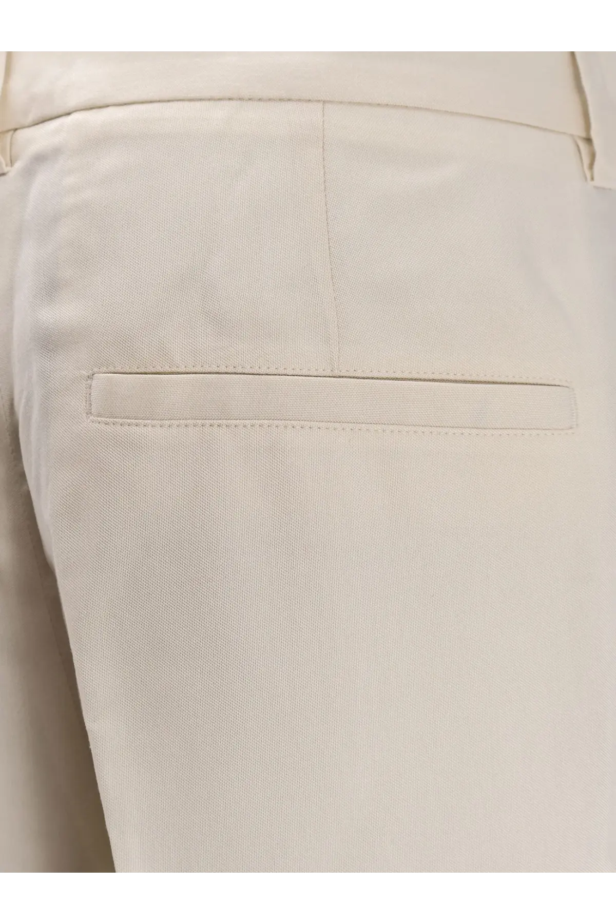 Toteme women’s cream-colored tailored viscose trousers with subtle woven texture and minimalist design