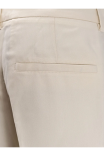 Toteme women’s cream-colored tailored viscose trousers with subtle woven texture and minimalist design