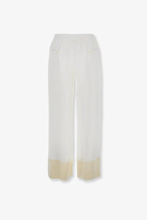 Toteme women’s white viscose wide-leg trousers with a subtle cream-colored hem for elegant wear