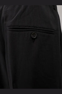 Toteme women’s black viscose and wool trousers with dark-wash denim fabric and black buttoned front pocket detail