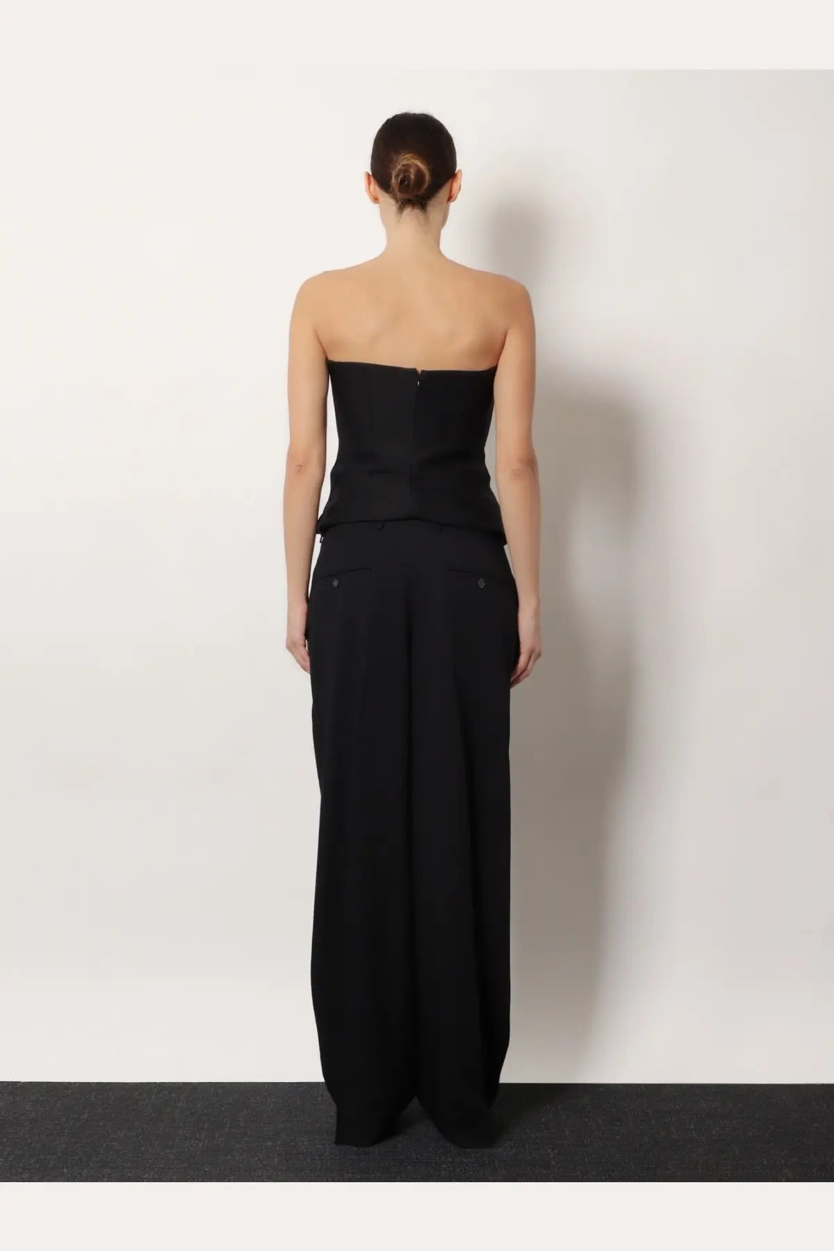 Black strapless corset top with structured bodice and toteme black viscose and wool wide-leg trousers set