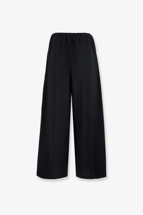 Black wide-leg wool trousers with elastic waistband from Toteme women’s collection shown from the front