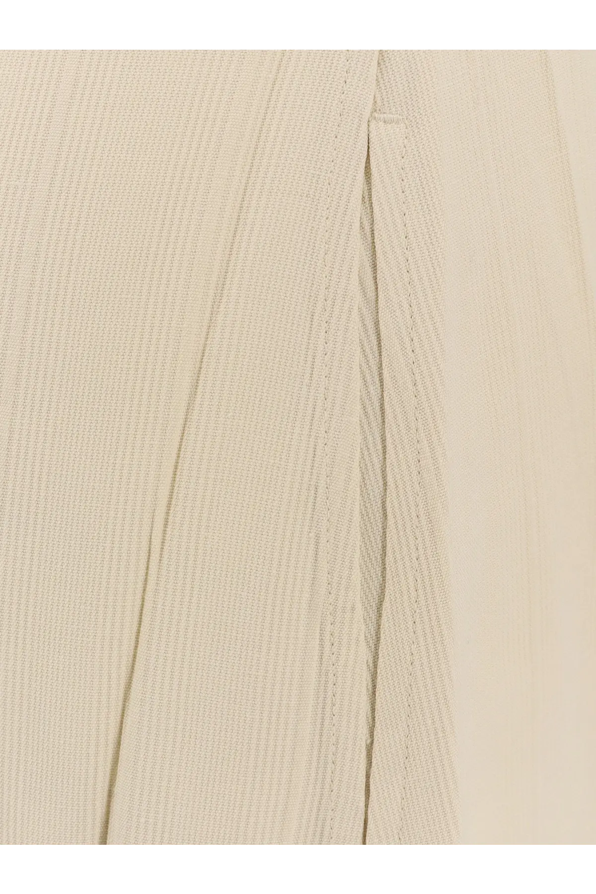 Beige linen trousers with subtle woven texture and precise stitching paired with toteme women’s woven stripes viscose long dress white