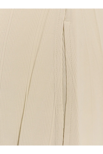 Beige linen trousers with subtle woven texture and precise stitching paired with toteme women’s woven stripes viscose long dress white