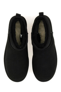 Ugg men’s boot classic ultra mini black showing plush shearling lining in black leather booties