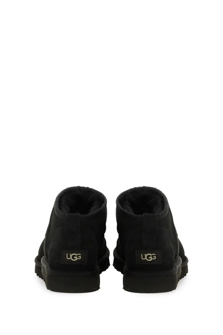 Ugg men’s boot classic ultra mini black showing black booties with plush lining and chunky rubber sole