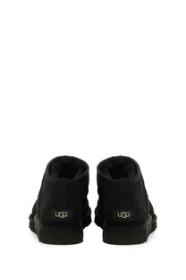 Ugg men’s boot classic ultra mini black showing black booties with plush lining and chunky rubber sole